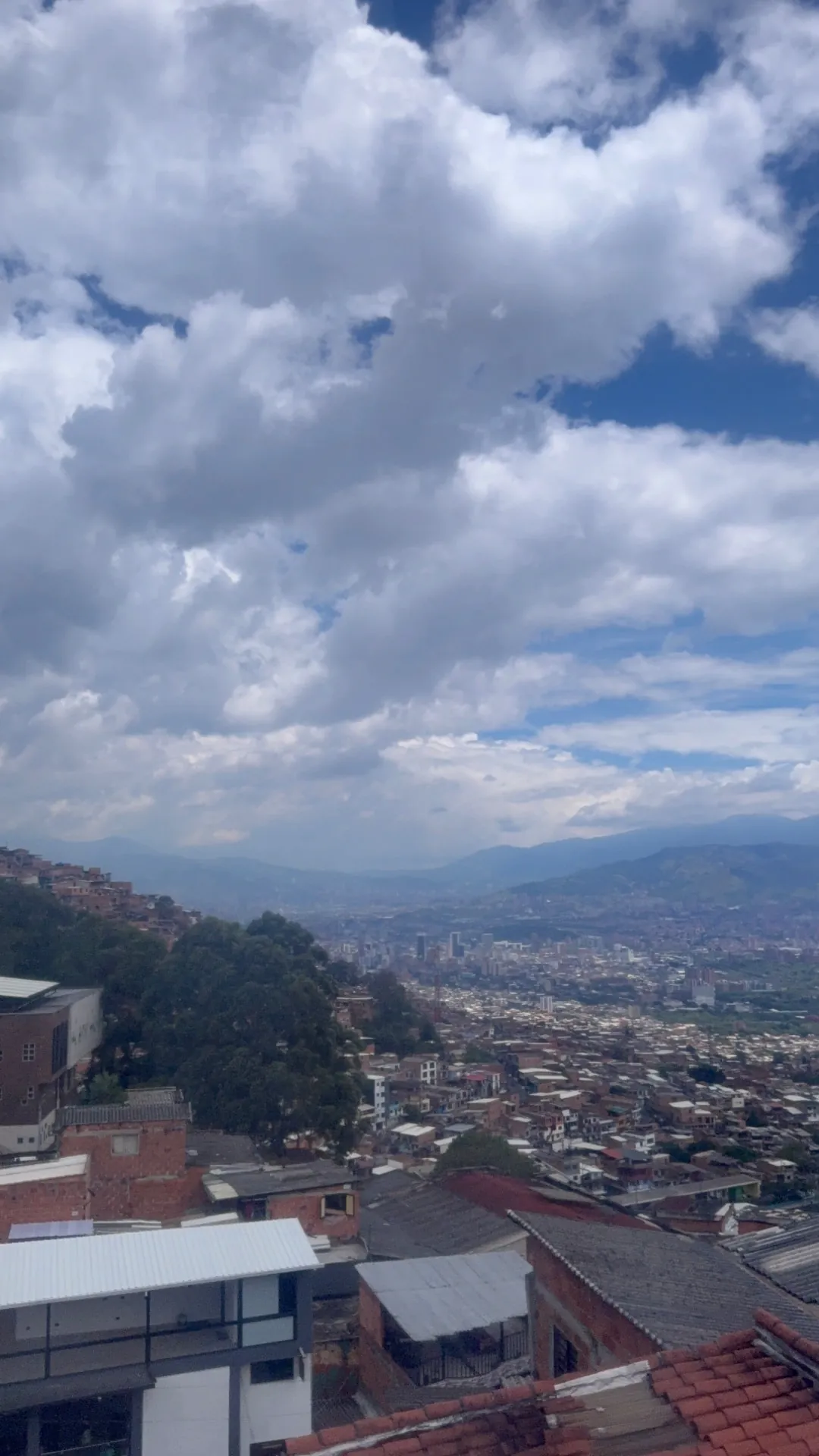 Panorama of Medellín seen from the hillside neighbourhood under a cloudy sky