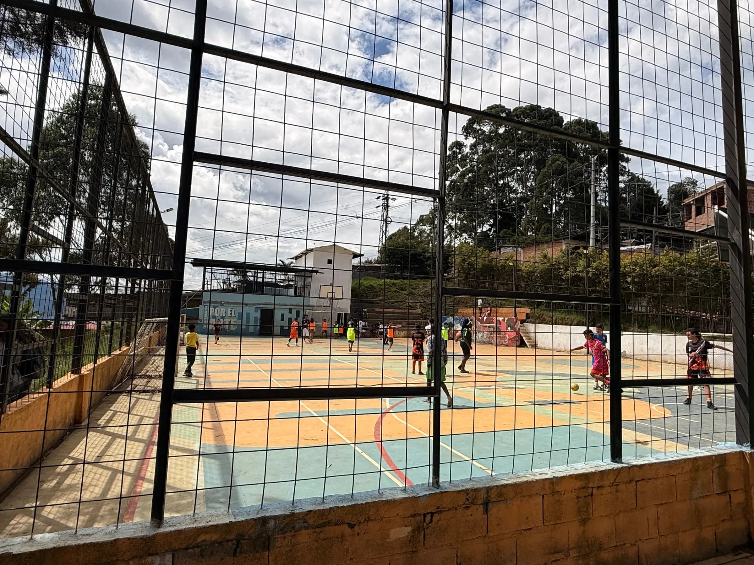 Children of Medellín Foundation: children playing football on the neighbourhood court