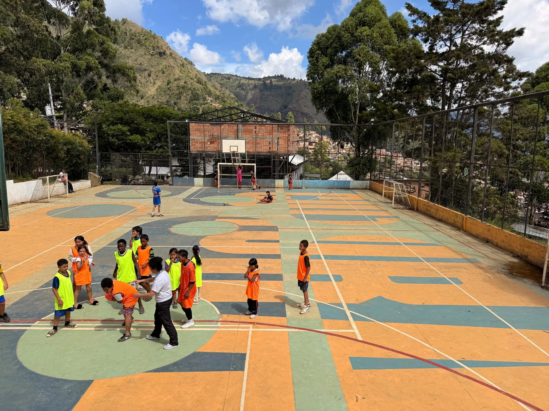 Children of Medellín Foundation: the neighbourhood sports court with the mountains behind it
